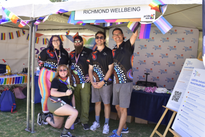 group of people smiling at fair stall