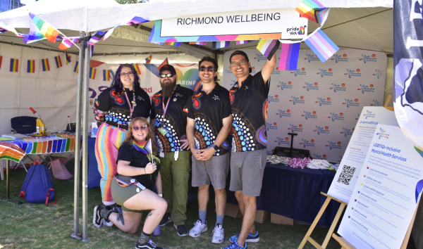 group of people smiling at fair stall