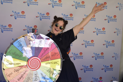 woman smiling with rainbow spinning wheel