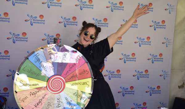 woman smiling with rainbow spinning wheel