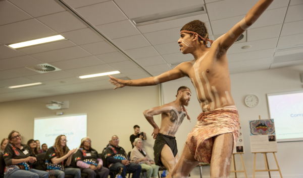 men dancing traditional Aboriginal dance in traditional clothing