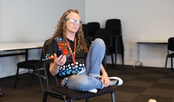 Woman sitting talking to a group