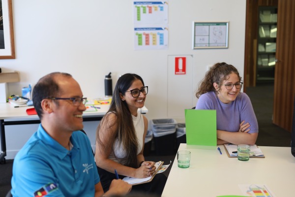 3 people sitting and smiling